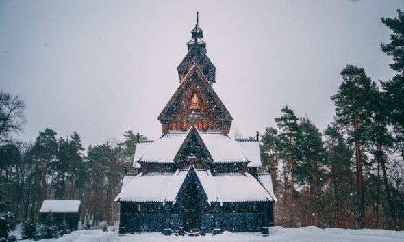 snow covered house beside trees 2299554