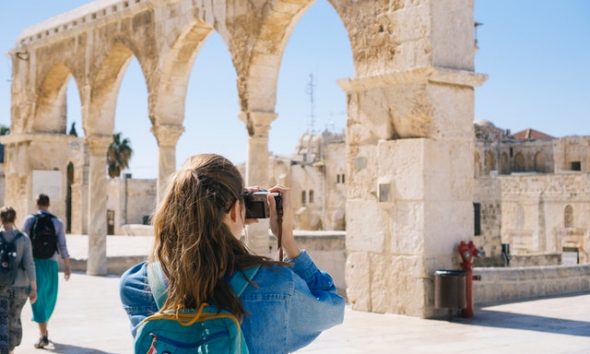 woman taking pictures of ruins 2087391